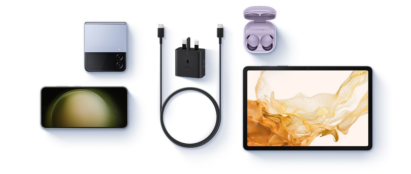 Samsung 25W Power Adapter without Cable Fast Charging for Smartphones, Tablets, Black 11 A birds-eye-view of various devices are shown with a black Power Adapter and a USB-C cable placed at the center. To the left, a Blue Galaxy Z Flip4 and a Galaxy S23 are shown. To the right, Buds 2 Pro in Bora Purple and a Galaxy Tab S8 are shown.